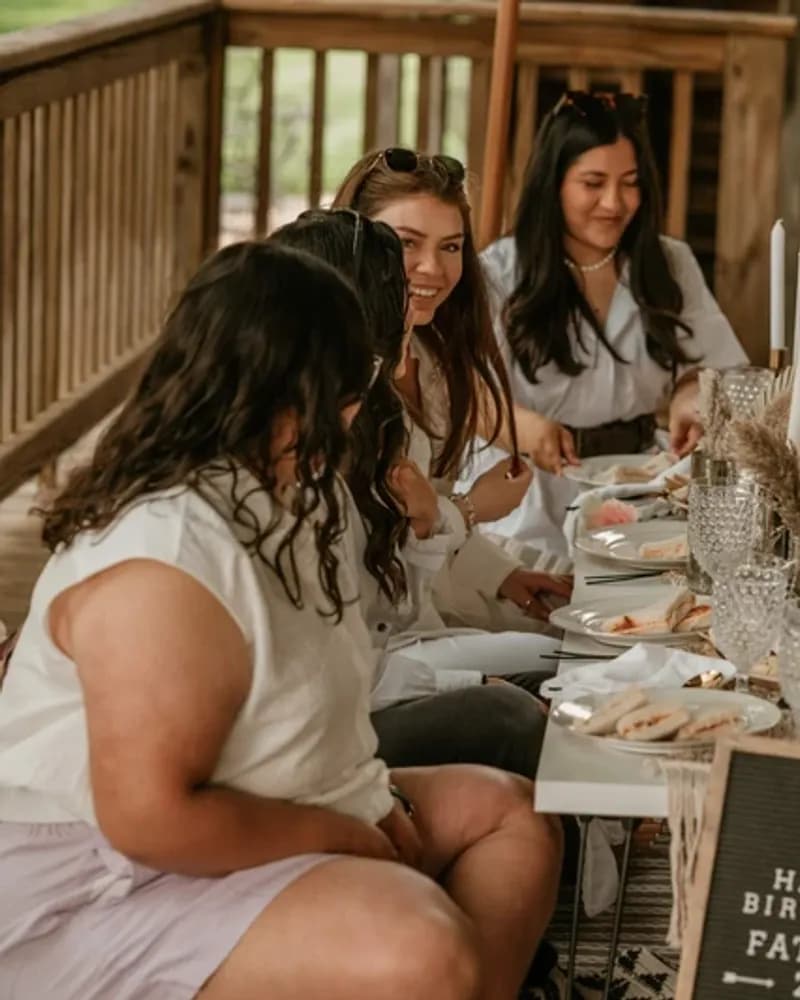 A luxe picnic set up with cushions, a low table and styled place settings.